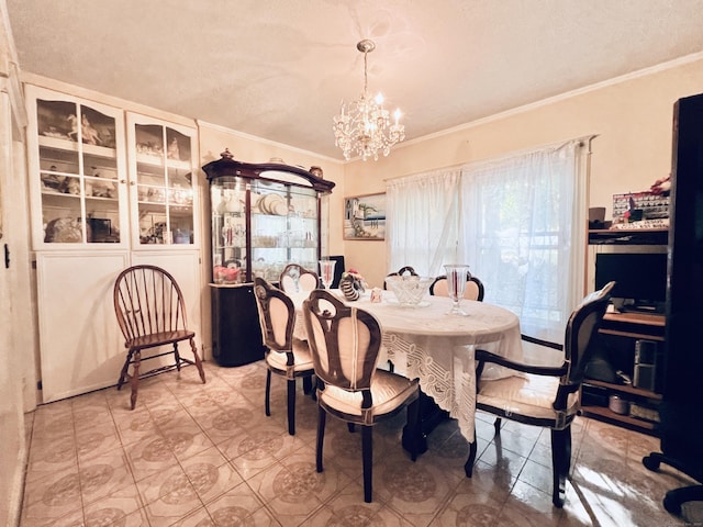 tiled dining area with a textured ceiling, an inviting chandelier, and ornamental molding