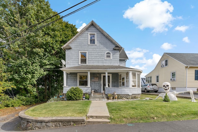 view of front of house with covered porch and a front yard