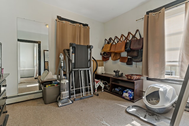 workout room featuring carpet flooring and baseboard heating