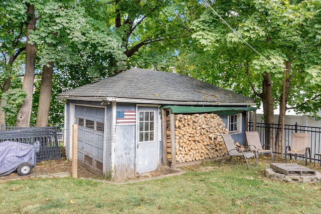 view of outbuilding featuring a lawn