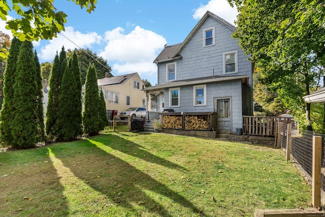 back of property featuring a lawn