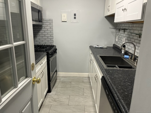 kitchen featuring backsplash, stainless steel appliances, white cabinetry, and sink