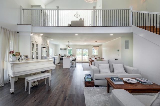 living area with an inviting chandelier, dark wood-style floors, and recessed lighting