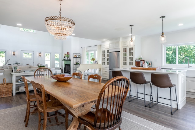 dining space featuring a notable chandelier, plenty of natural light, and dark wood-type flooring