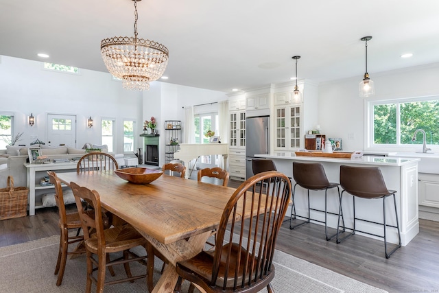 dining room with recessed lighting, a notable chandelier, and wood finished floors