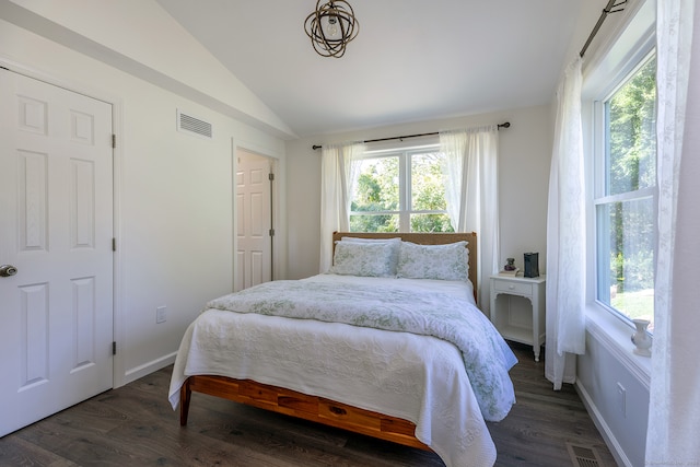 bedroom featuring lofted ceiling and dark hardwood / wood-style flooring