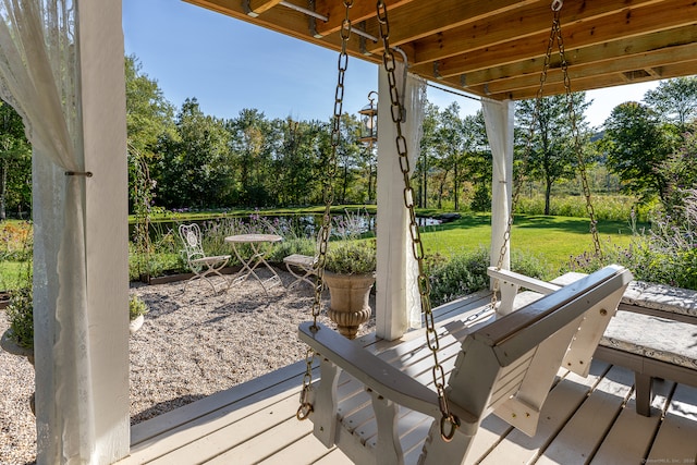 wooden terrace featuring a yard and a patio area