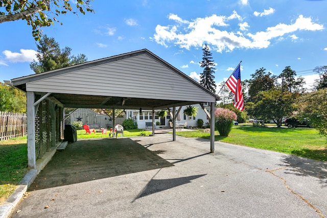 view of car parking with a yard and a carport