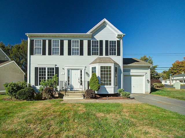 view of front of house featuring a garage and a front yard