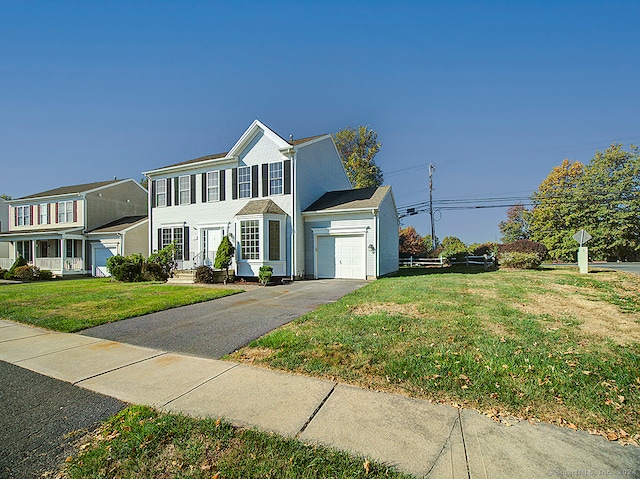 view of front of property featuring a front lawn and a garage