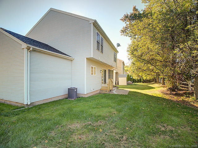 back of house with a yard and cooling unit