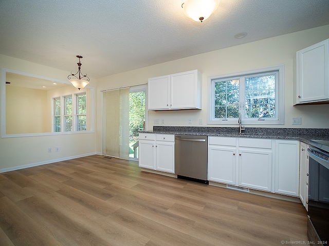 kitchen featuring dishwasher, plenty of natural light, and white cabinetry