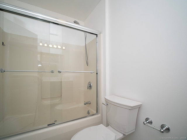 bathroom with toilet and enclosed tub / shower combo