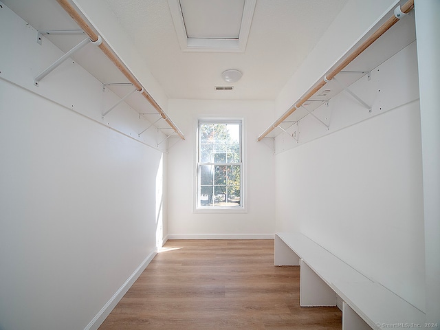 spacious closet featuring light hardwood / wood-style floors