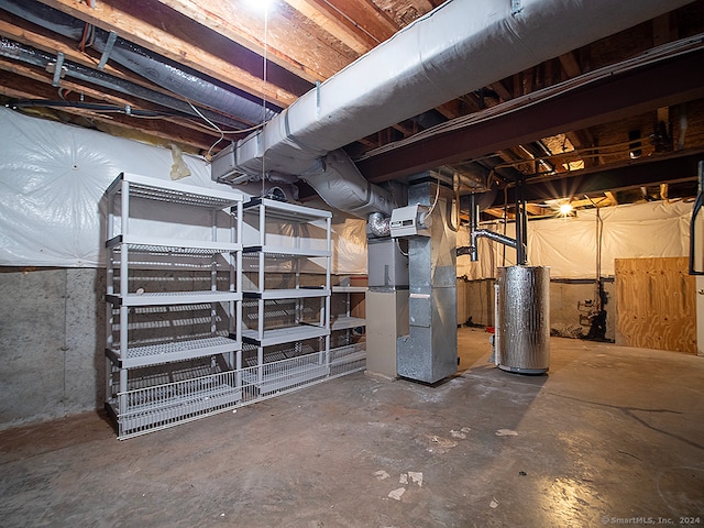 basement featuring gas water heater and heating unit