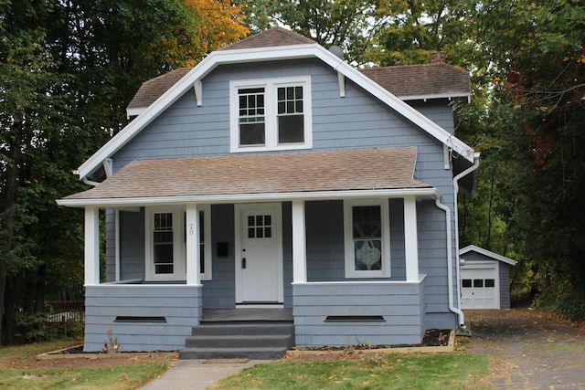 bungalow-style home featuring an outdoor structure and a garage