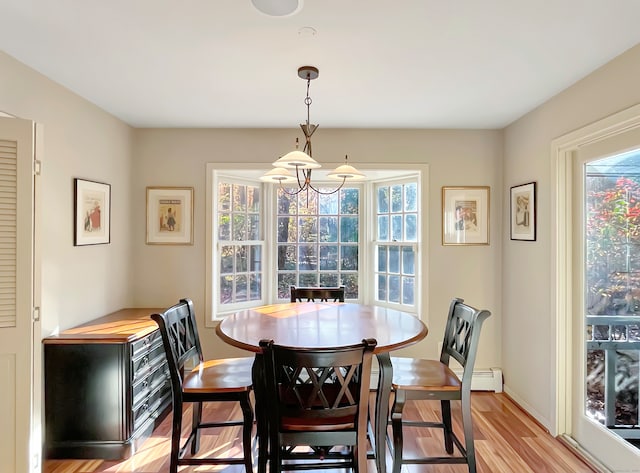 dining room featuring light wood-type flooring and baseboard heating