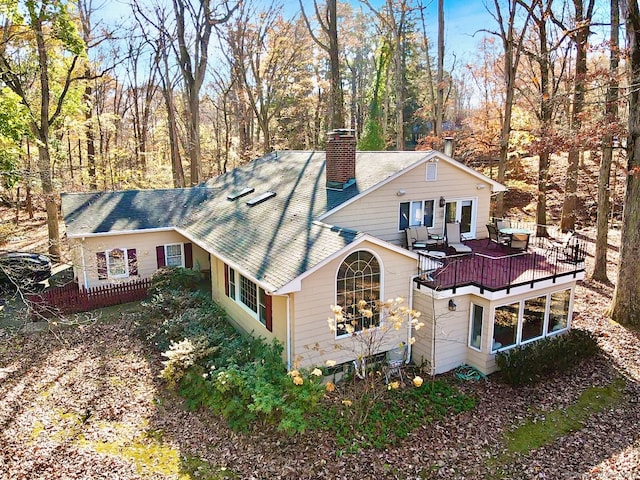 view of property exterior featuring a wooden deck