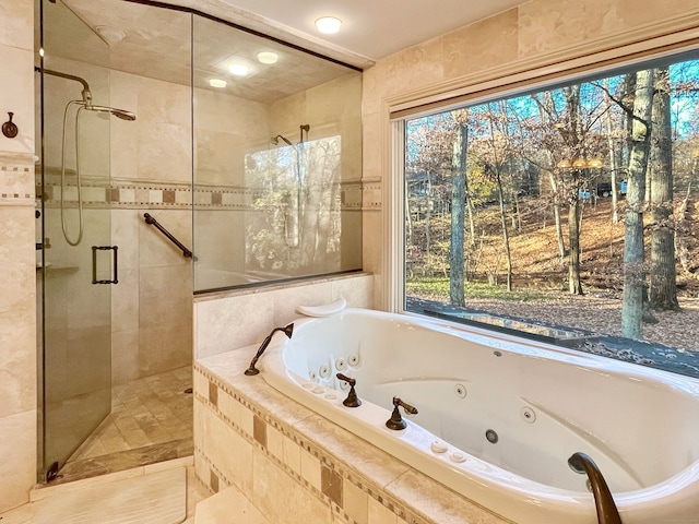 bathroom featuring independent shower and bath