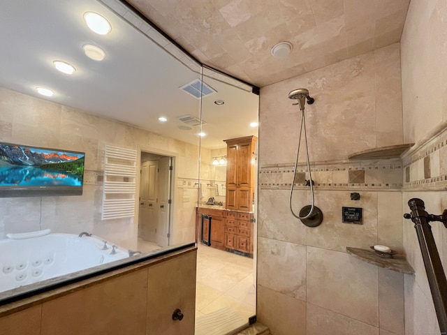 bathroom featuring vanity, radiator heating unit, tile walls, and plus walk in shower