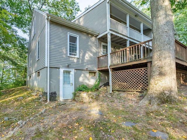 rear view of house featuring a deck