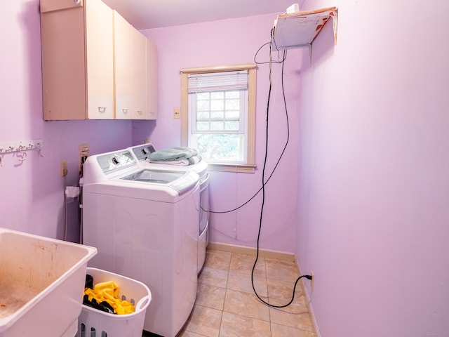 laundry room featuring cabinets, sink, independent washer and dryer, and light tile patterned flooring