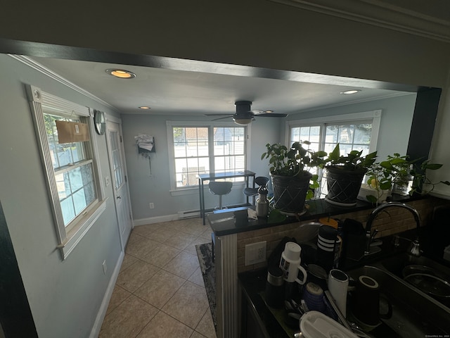 interior space featuring ceiling fan, ornamental molding, plenty of natural light, and light tile patterned floors