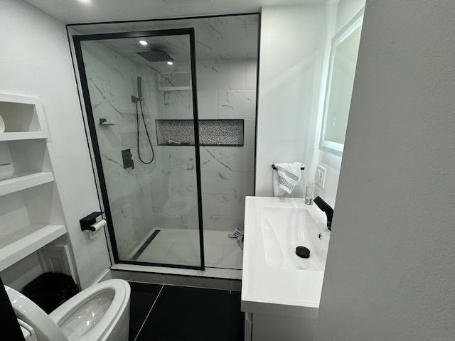 bathroom featuring vanity, toilet, a shower with door, and tile patterned floors