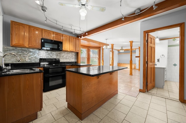 kitchen with light tile patterned flooring, black appliances, sink, and a center island