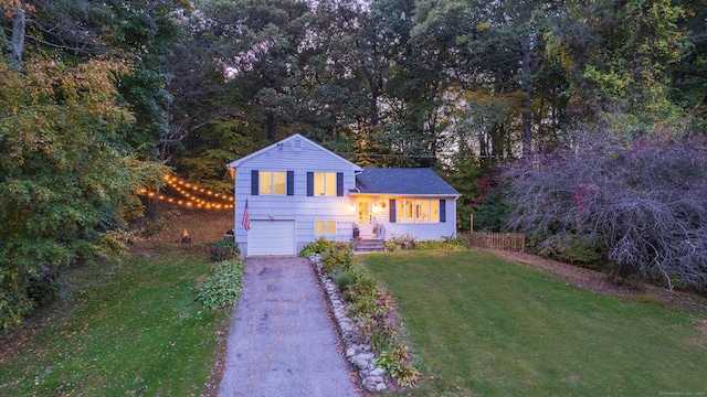 split level home with a front lawn and a garage