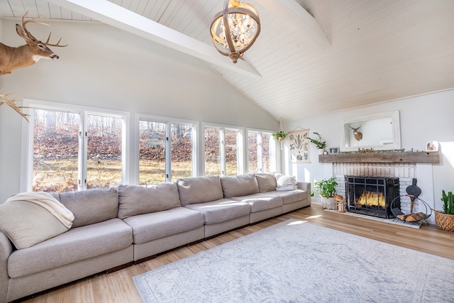 living room featuring a brick fireplace, beamed ceiling, high vaulted ceiling, wood ceiling, and light wood-type flooring