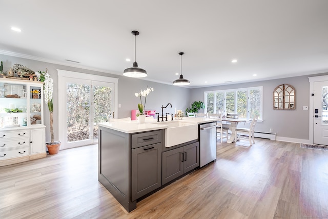 kitchen with sink, stainless steel dishwasher, decorative light fixtures, gray cabinets, and light wood-type flooring