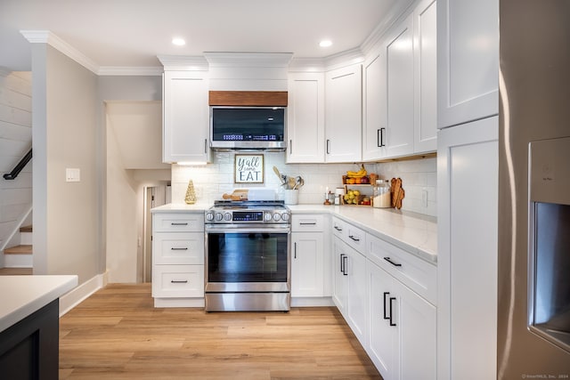 kitchen with light hardwood / wood-style flooring, white cabinets, and stainless steel appliances