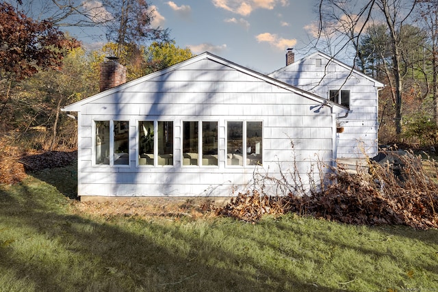 view of property exterior with a yard