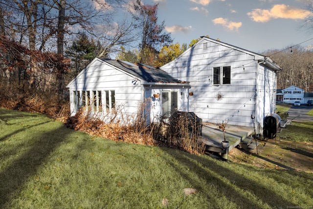 back of house with a lawn