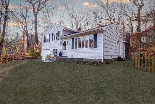 view of front of property featuring a lawn and a garage