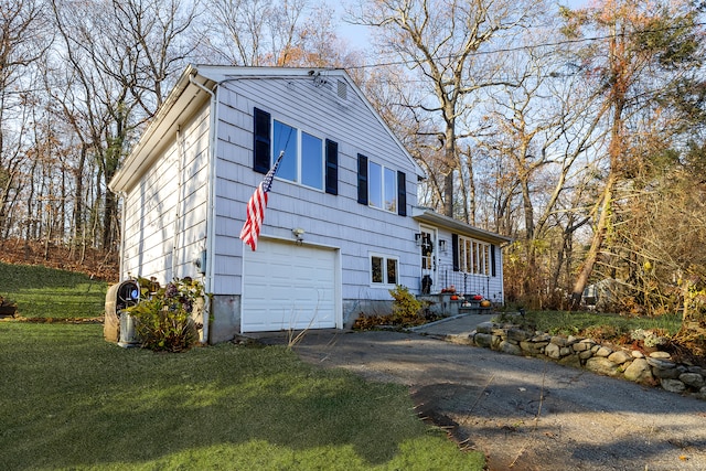 view of front of property featuring a garage and a front lawn