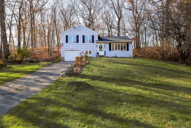 tri-level home with a front yard and a garage