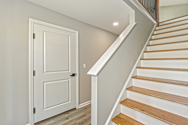 stairway featuring hardwood / wood-style flooring