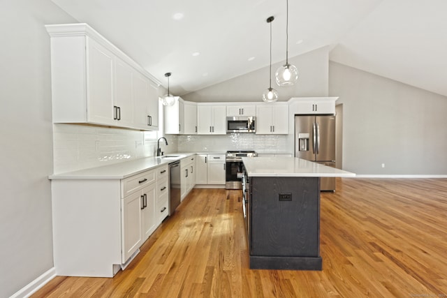 kitchen with a center island, sink, light hardwood / wood-style flooring, appliances with stainless steel finishes, and white cabinetry