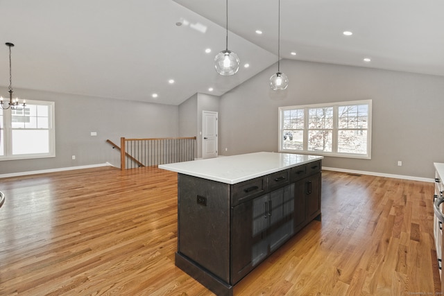 kitchen featuring pendant lighting, light hardwood / wood-style flooring, plenty of natural light, and a kitchen island