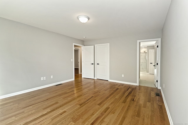 unfurnished bedroom with light wood-type flooring