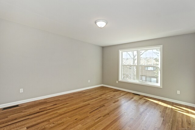 unfurnished room featuring hardwood / wood-style flooring