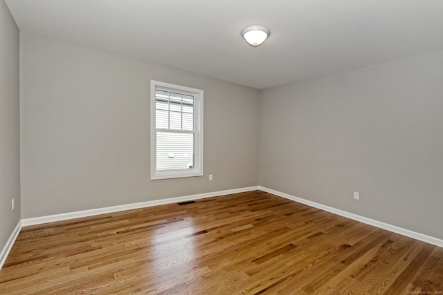 unfurnished room featuring wood-type flooring