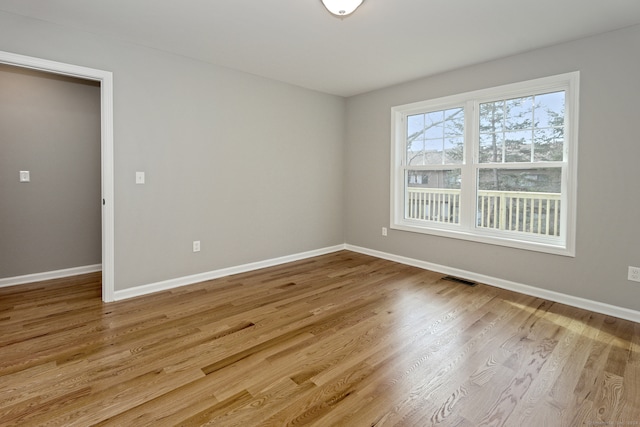 empty room with light hardwood / wood-style flooring