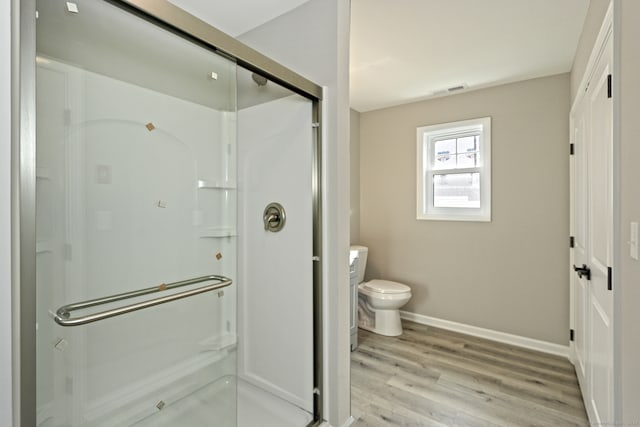 bathroom with walk in shower, toilet, vanity, and hardwood / wood-style flooring