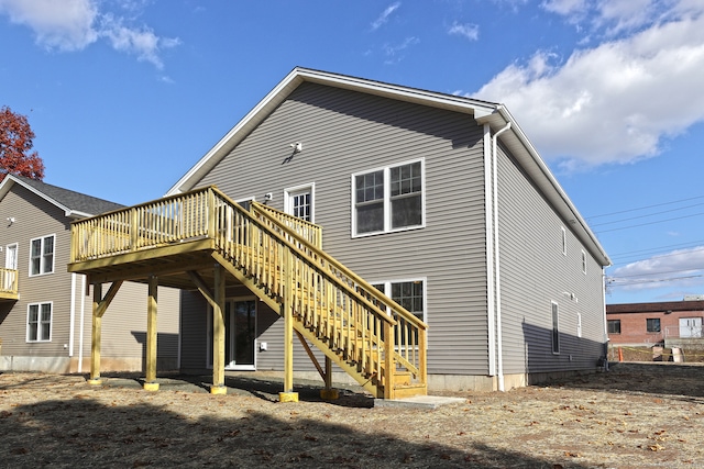 rear view of property featuring a deck