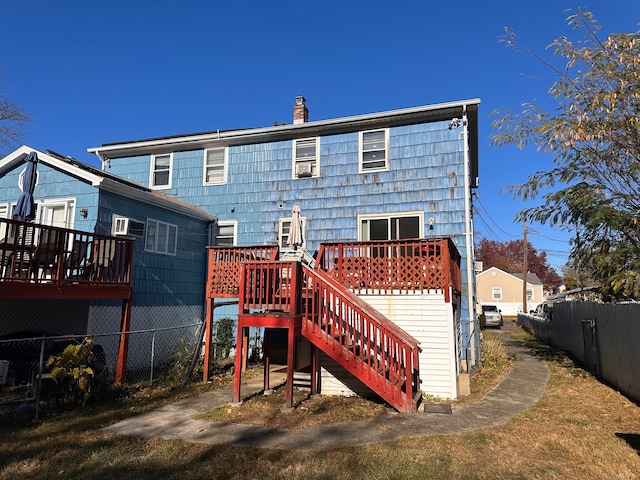 rear view of property with a wooden deck