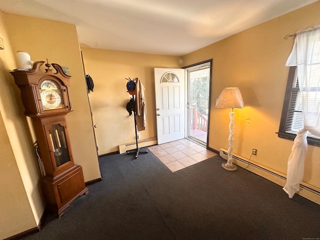 carpeted entrance foyer with a baseboard heating unit