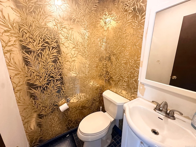 bathroom featuring tile patterned floors, toilet, and sink